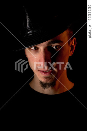 Studio portrait of surprised handsome man in hat over black back 4353159