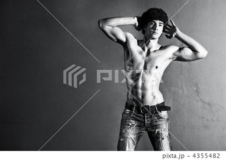 Young muscular man on wall background 4355482