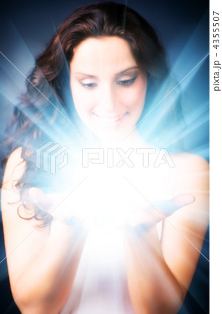 Young woman with magic shine in hands 4355507