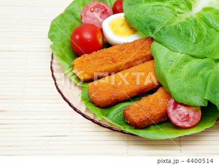 Fish sticks with egg salad on a platter. 4400514