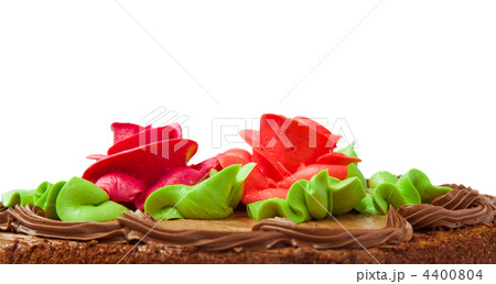 Chocolate cake with two cream-colored roses. Isolated on white background. 4400804