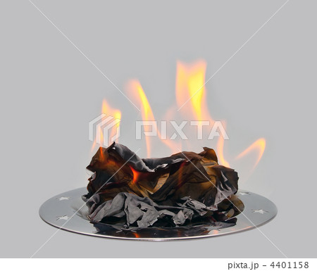 Burning paper on a metal tray. Burning paper on a metal tray. 4401158