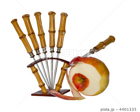Partially purified red apple and a set of fruit knives, isolated Partially purified red apple and a set of fruit knives, isolated 4401335