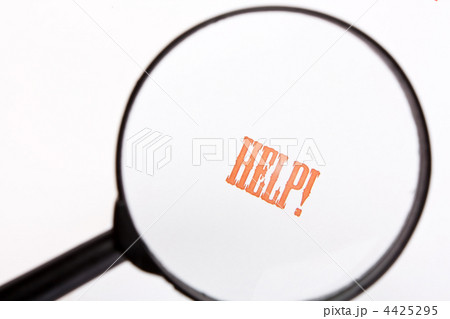 Loupe analysing the word "help" in front of a white background 4425295