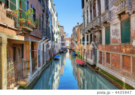 Narrow canal among ancient houses. Venice, Italy. 4435947