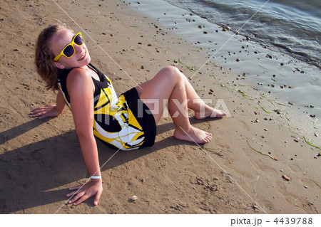 Young girl sitting on the beach. Young girl sitting on the beach. 4439788
