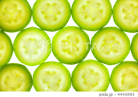 Slices of zucchini or courgette isolated on white / back lit Slices of zucchini or courgette isolated on white / back lit 4443093