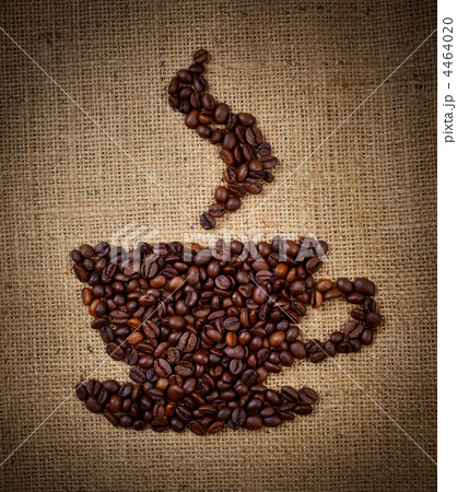 coffee cup made from beans on burlap background coffee cup made from beans on burlap background 4464020