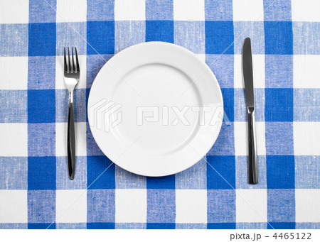 Knife, white plate and fork on blue checked tablecloth Knife, white plate and fork on blue checked tablecloth 4465122