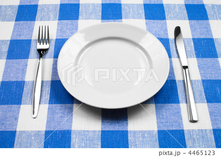 Knife, white plate and fork on blue checked tablecloth Knife, white plate and fork on blue checked tablecloth 4465123