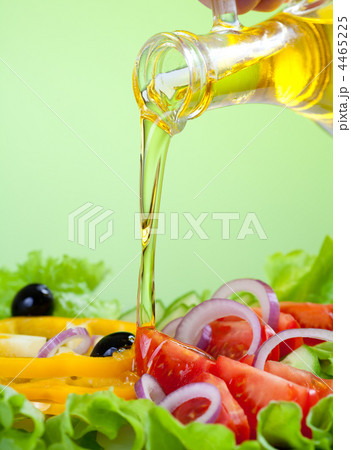 sunflower seed oil stream and healthy fresh vegetable salad 4465225