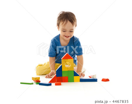 Cute little boy is playing with colorful building wooden blocks 4467835