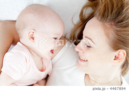 Happy young mother and her baby in bed top view 4467894