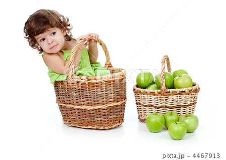 Adorable little girl with green apples in basket isolated studio 4467913