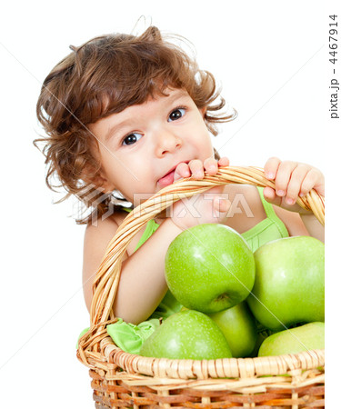 Adorable little girl with green apples in basket isolated studio 4467914