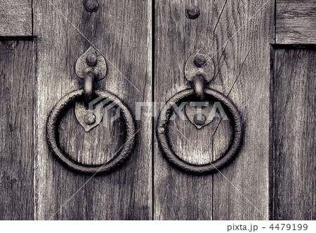 ancient wooden gate with door knocker rings 4479199