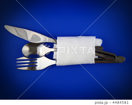 Table serving-knife,spoon,fork on blue backdrop. 4484581