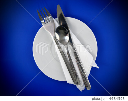Table serving-knife,spoon,fork on blue backdrop. 4484593