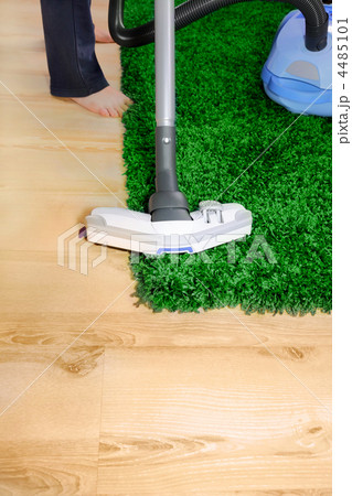 Vacuum cleaner in action - men cleaner a carpet. 4485101