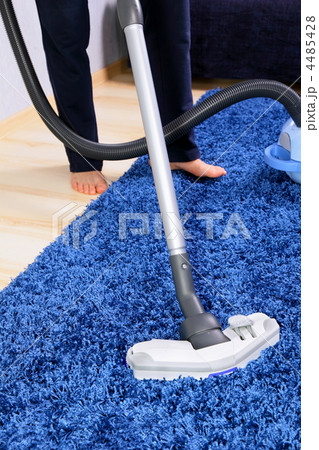 Vacuum cleaner in action-men cleaner a carpet. Vacuum cleaner in action-men cleaner a carpet. 4485428