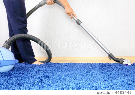Vacuum cleaner in action-men cleaner a carpet. 4485443