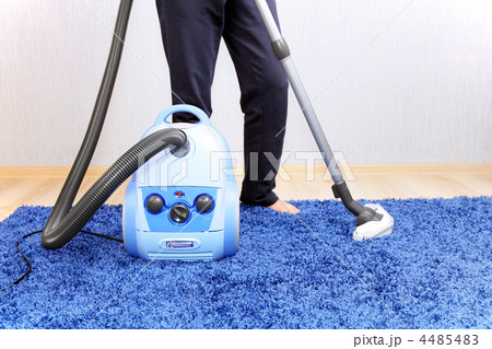 Vacuum cleaner in action-men cleaner a carpet. 4485483