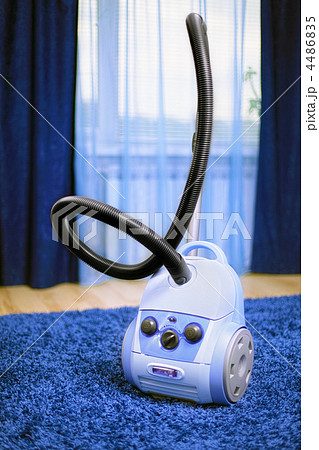 Vacuum cleaner stand  on blue carpet. 4486835