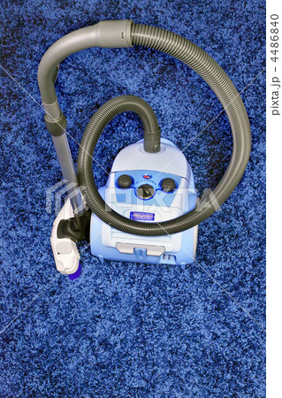 Vacuum cleaner stand  on blue carpet. 4486840