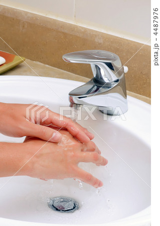 Washing hands in sink. 4487976