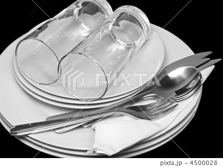Pile of white plates, glasses, forks, spoons. 4500028
