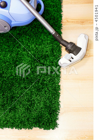 Vacuum cleaner on green carpet Vacuum cleaner on green carpet 4501941