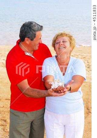 Elderly couple on the coast ,holding corals. Elderly couple on the coast ,holding corals. 4511833
