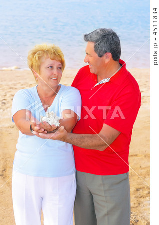 Elderly couple on the coast ,holding corals. Elderly couple on the coast ,holding corals. 4511834