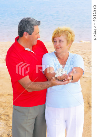 Elderly couple on the coast ,holding corals. Elderly couple on the coast ,holding corals. 4511835