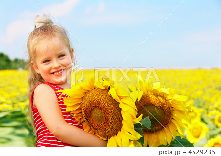Kid holding sunflower outdoor. 4529235