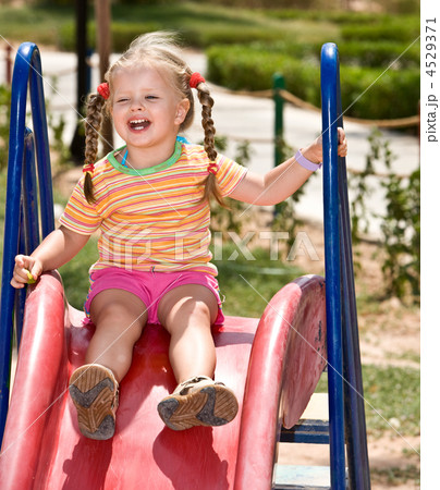 Child   on slide in playground.Outdoor park. 4529371