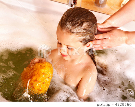 Kid washing hair by shampoo . Kid washing hair by shampoo . 4529560