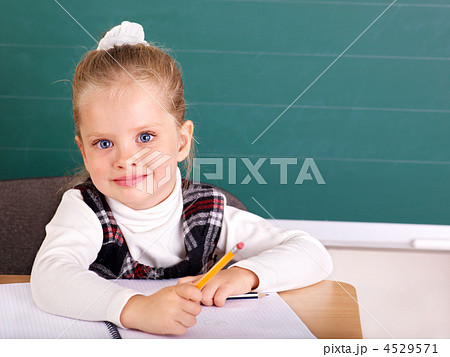 Schoolchild in classroom near blackboard. 4529571