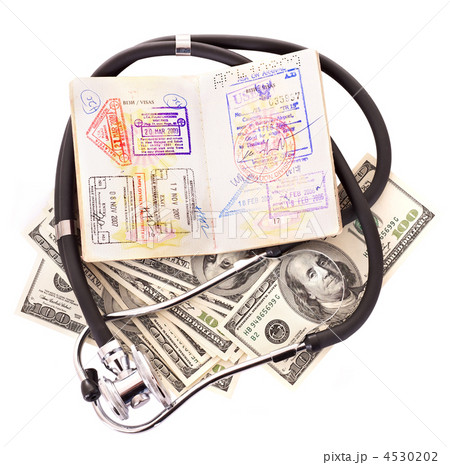 Medical still life with stethoscope, money and passport. 4530202