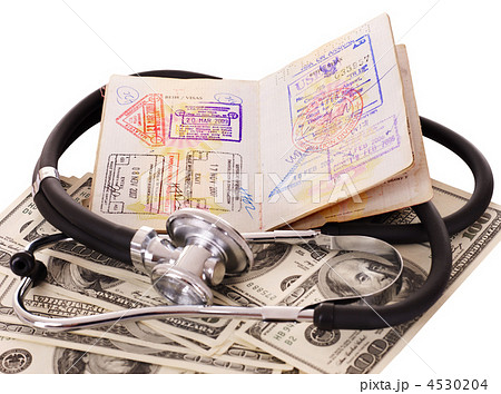 Medical still life with stethoscope, money and passport. 4530204