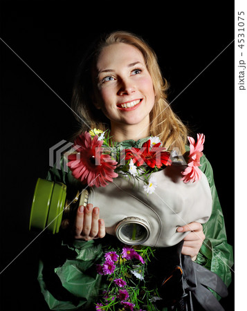 Woman holding flowers and gas mask . Woman holding flowers and gas mask . 4531075
