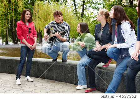 Group of people in city park listen music. Group of people in city park listen music. 4557552