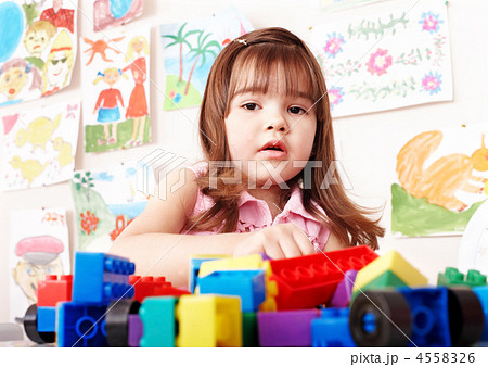 Child playing construction set in play room. 4558326