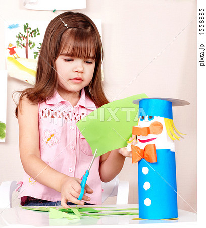 Serious child cutting paper. 4558335