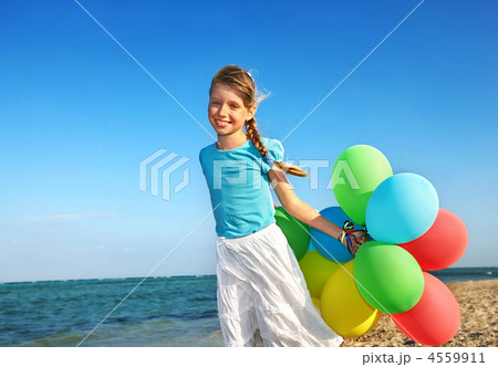 Child playing with balloons at the beach 4559911