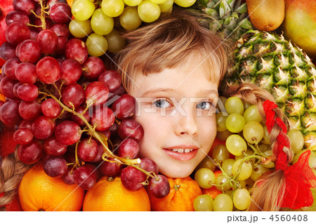 Child girl in group of fruit. 4560408