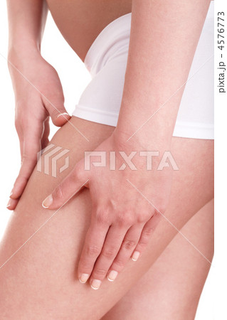 Young woman applying cosmetic cream on leg. 4576773