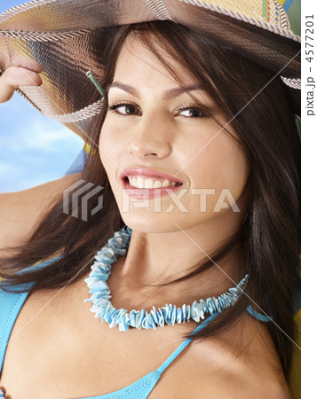 Girl in bikini and hat on beach. 4577201