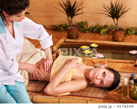 Woman getting massage in bamboo spa. Woman getting massage in bamboo spa. 4578349