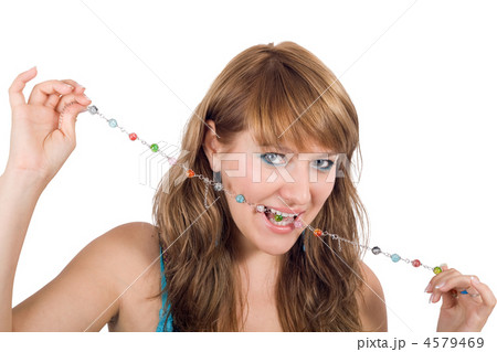 Portrait of the young beautiful woman with a beads in a teeth. I Portrait of the young beautiful woman with a beads in a teeth. I 4579469